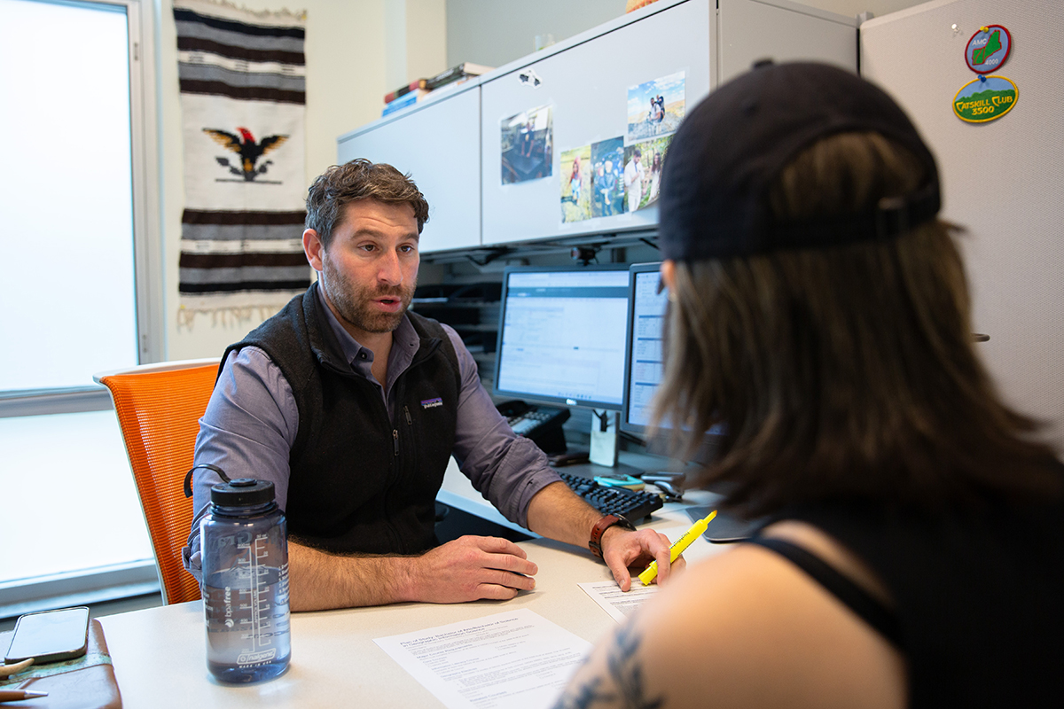 Advisor Matthew Donofrio meets with a student in his office.